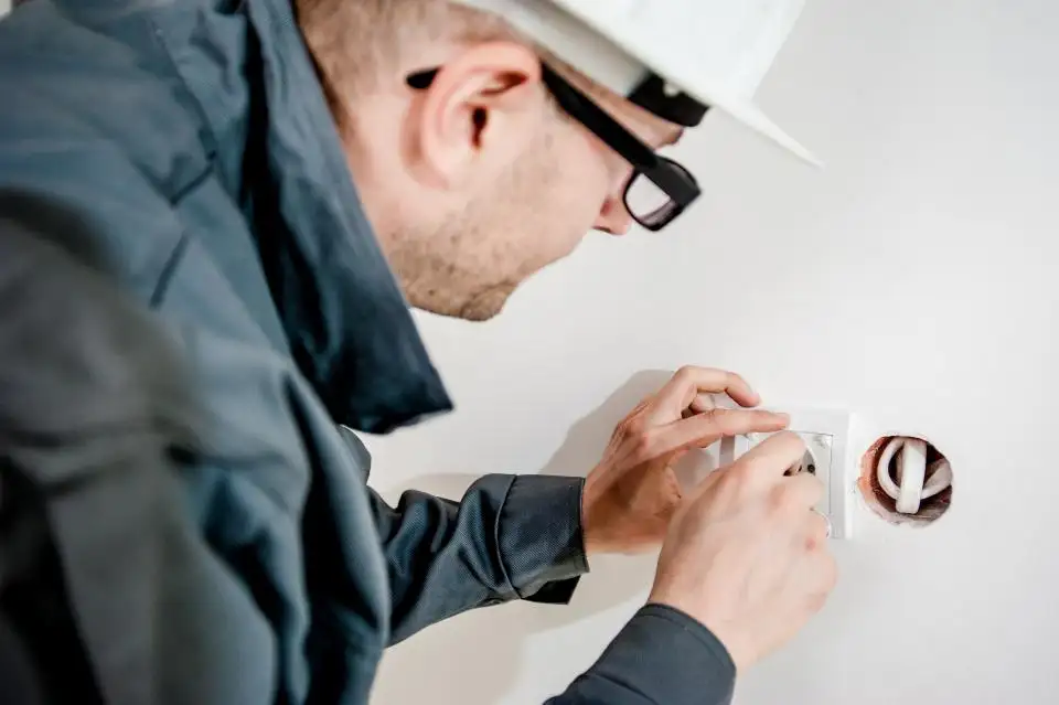Electricista reparando un enchufe en una vivienda